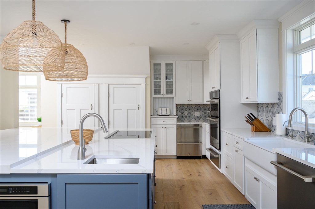 133 Beach Avenue Hull, MA 02045 - Photo 10 of 42 a kitchen with a sink stainless steel appliances and cabinets