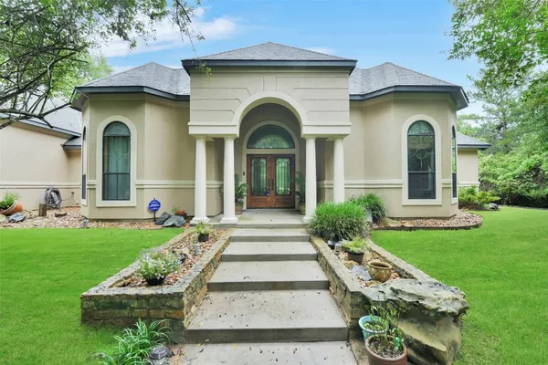a front view of a house with garden
