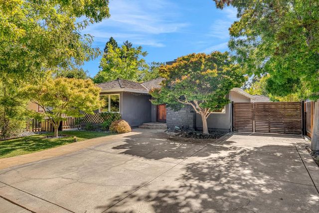 a view of a house with a yard and garage