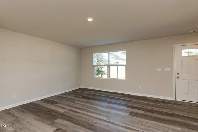 wooden floor in an empty room with a window