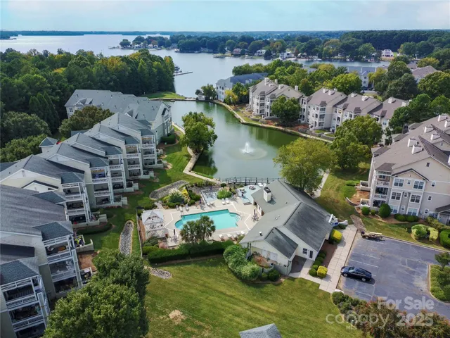 an aerial view of multiple houses with yard