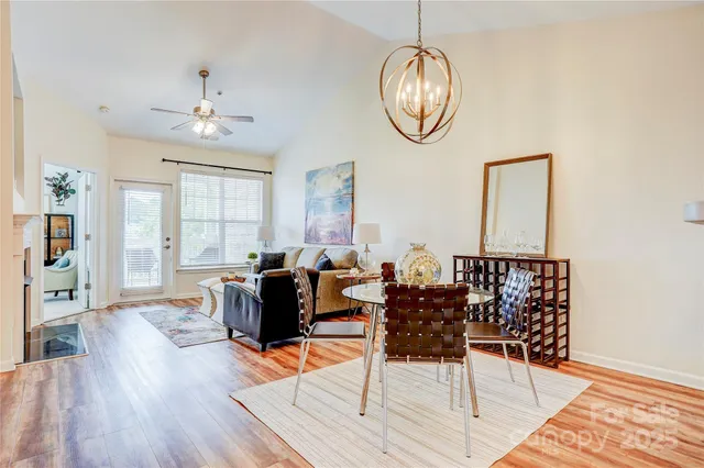 a living room with dining table and a window