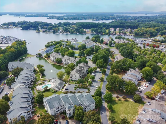 an aerial view of lake and residential houses with outdoor space