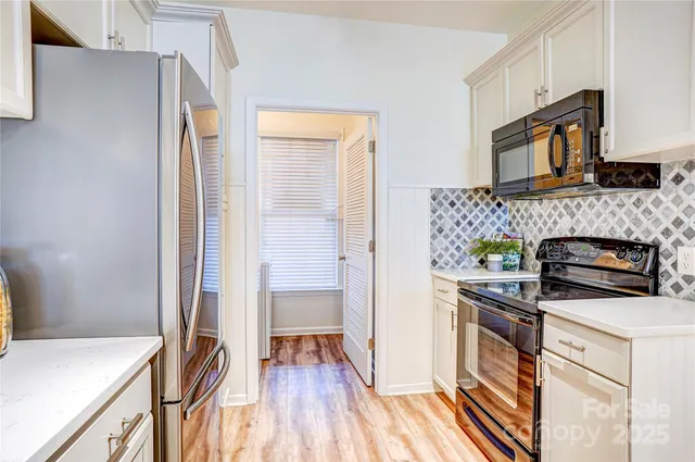 a kitchen with stainless steel appliances a stove a sink and a refrigerator