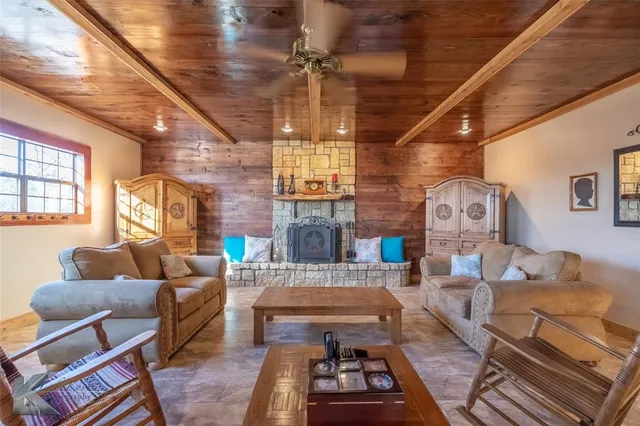 a living room with furniture a fireplace and a table