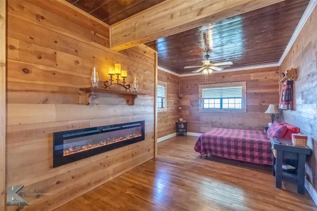 a bedroom with furniture and wooden floor