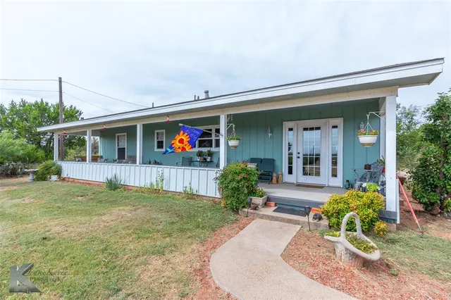 a view of a house with porch and garden