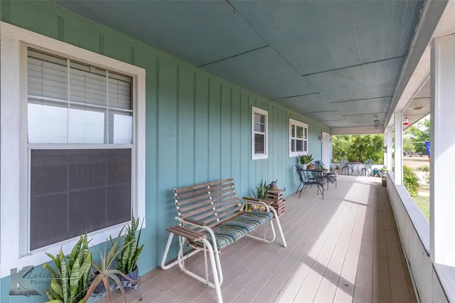 a view of a patio with table and chairs and potted plants