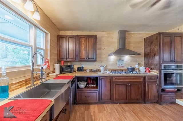 a kitchen with a sink stove and cabinets