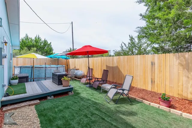 a view of backyard with outdoor seating and plants