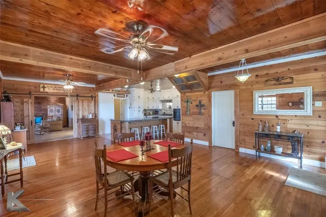 a dining room with furniture and wooden floor
