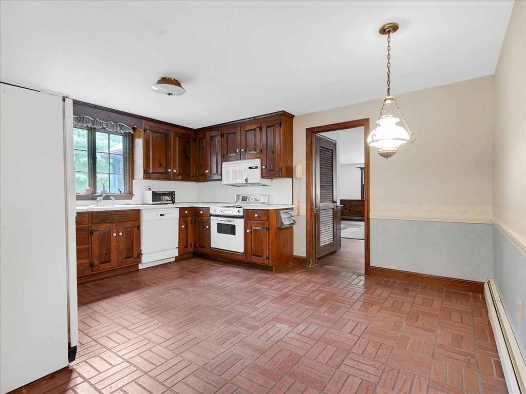 70 Parsonage Lane Topsfield, MA 01983 - Photo 12 of 29 a kitchen with stainless steel appliances granite countertop a stove top oven a refrigerator a sink and dishwasher