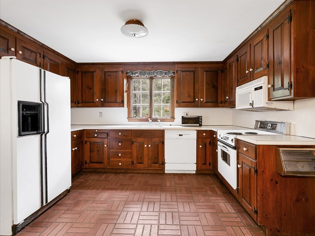 70 Parsonage Lane Topsfield, MA 01983 - Photo 13 of 29 a kitchen with stainless steel appliances granite countertop a stove refrigerator sink and cabinets