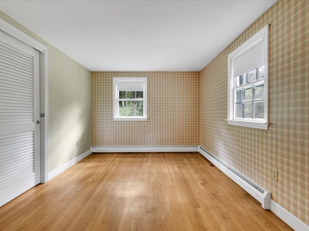 70 Parsonage Lane Topsfield, MA 01983 - Photo 21 of 29 a view of an empty room with wooden floor and a window