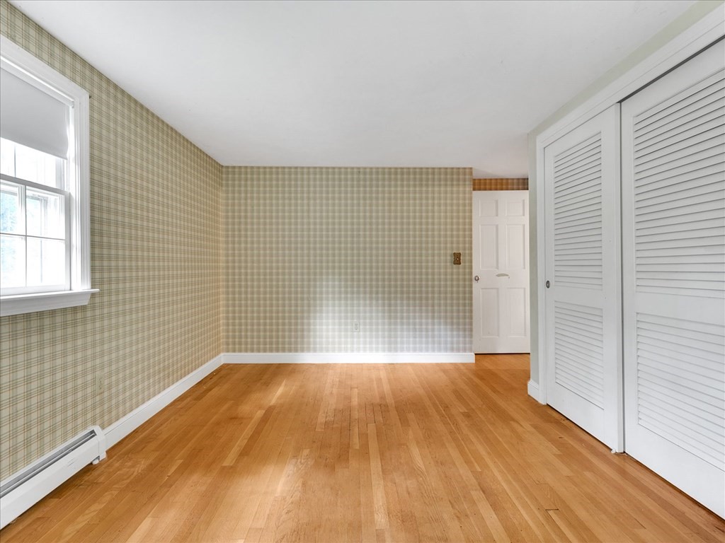 70 Parsonage Lane Topsfield, MA 01983 - Photo 22 of 29 a view of empty room with wooden floor and fan