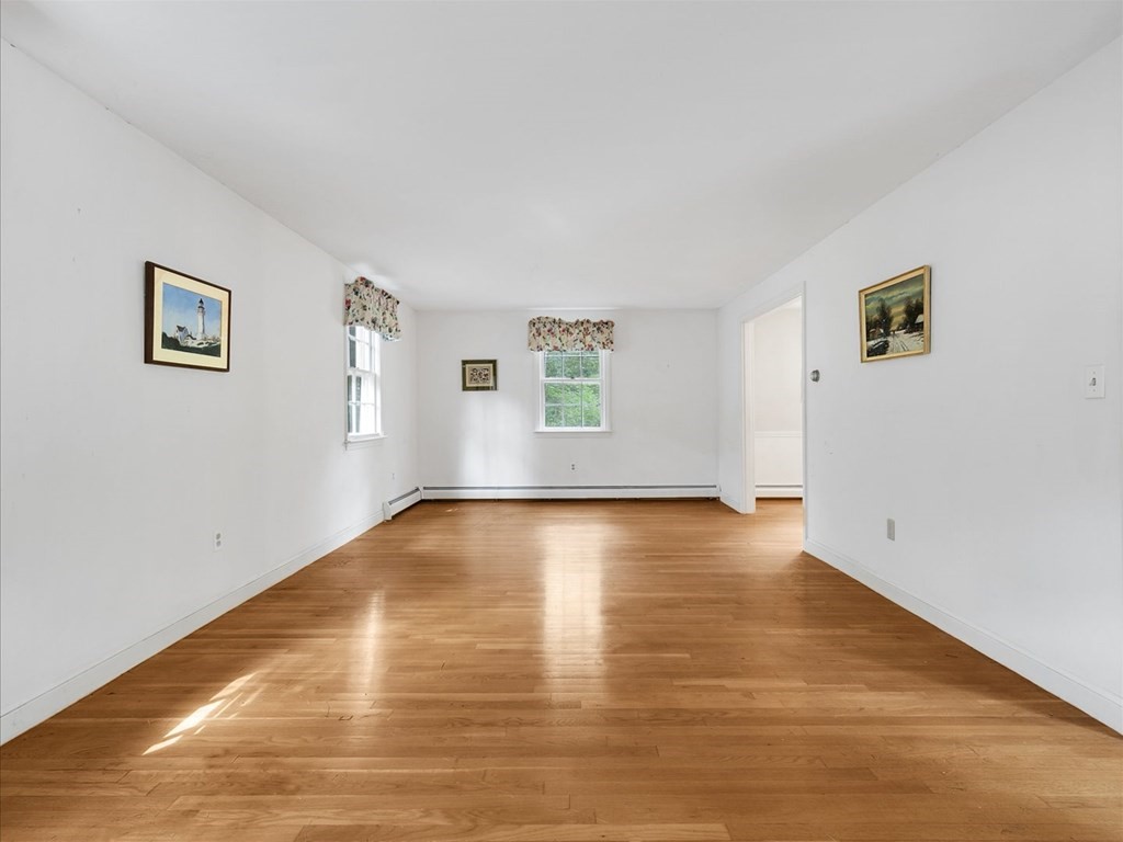 70 Parsonage Lane Topsfield, MA 01983 - Photo 9 of 29 a view of empty room with wooden floor and fan