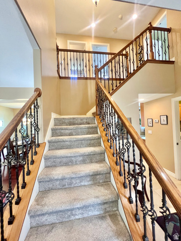 369 Culross Circle Tooele, UT 84074 - Photo 19 of 54 Grand staircase featuring decorative wrought iron balusters and wood handrails
