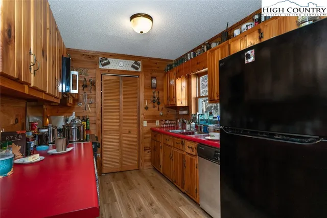 a kitchen with refrigerator and cabinets