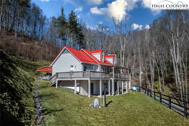 a view of a house with a yard deck and a garden