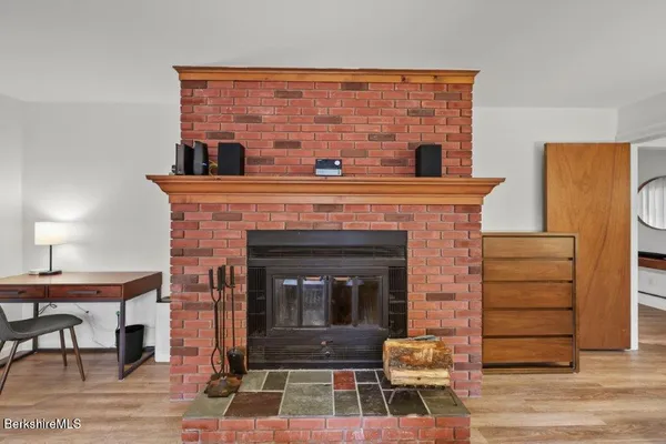 a living room with a fireplace and a table