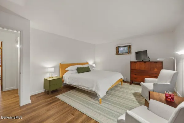 a bedroom with a bed and a couch