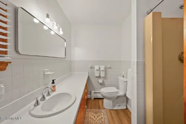a bathroom with a sink toilet and shower