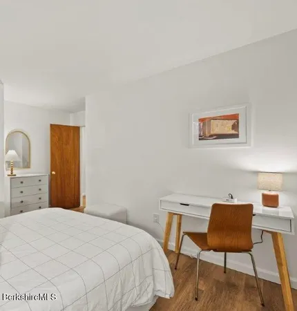 a bedroom with a bed and a chair