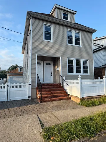 a view of a house with a door and a yard