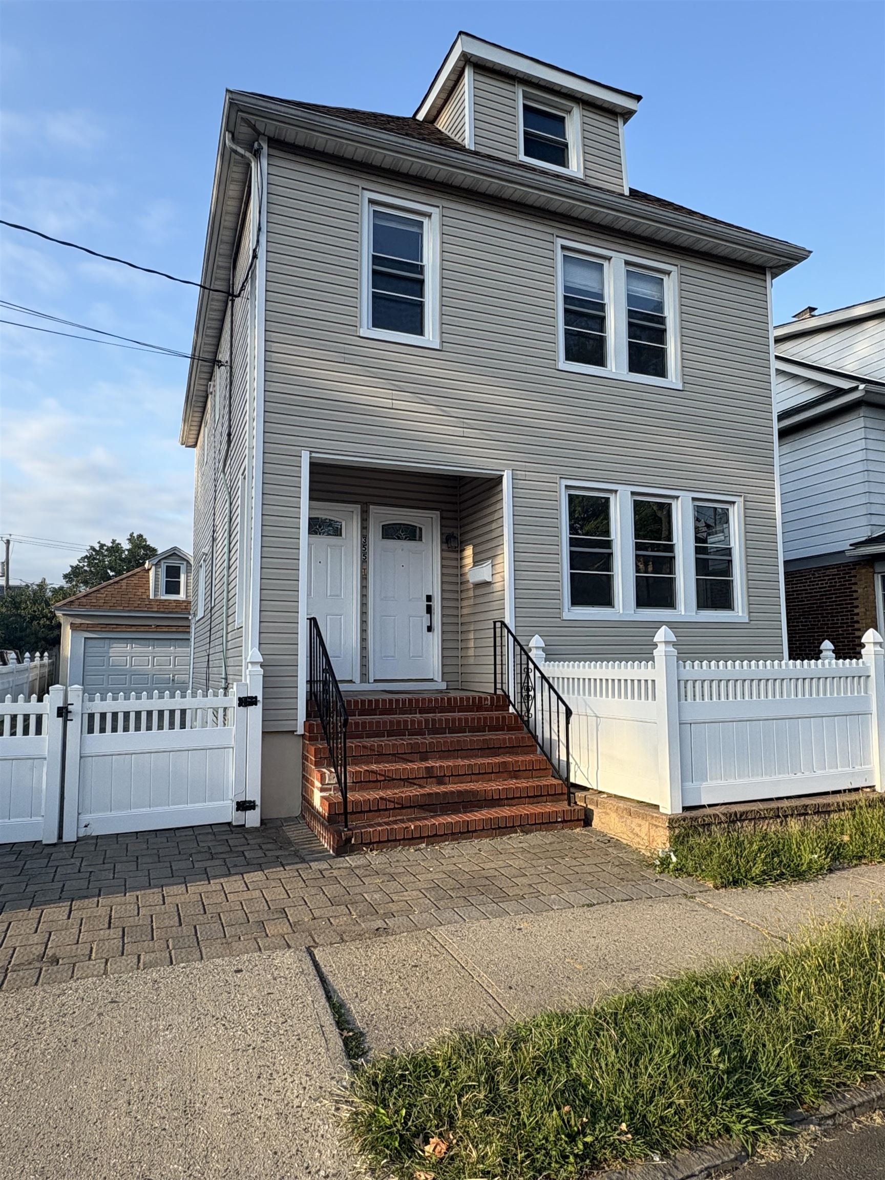 a view of a house with a door and a yard