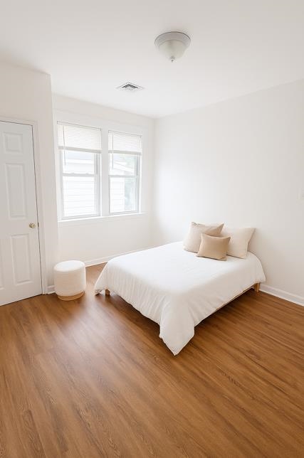 355 Princeton Avenue, Unit 2 Hillside, NJ 07205 - Photo 11 of 11 a bedroom with a bed and wooden floor