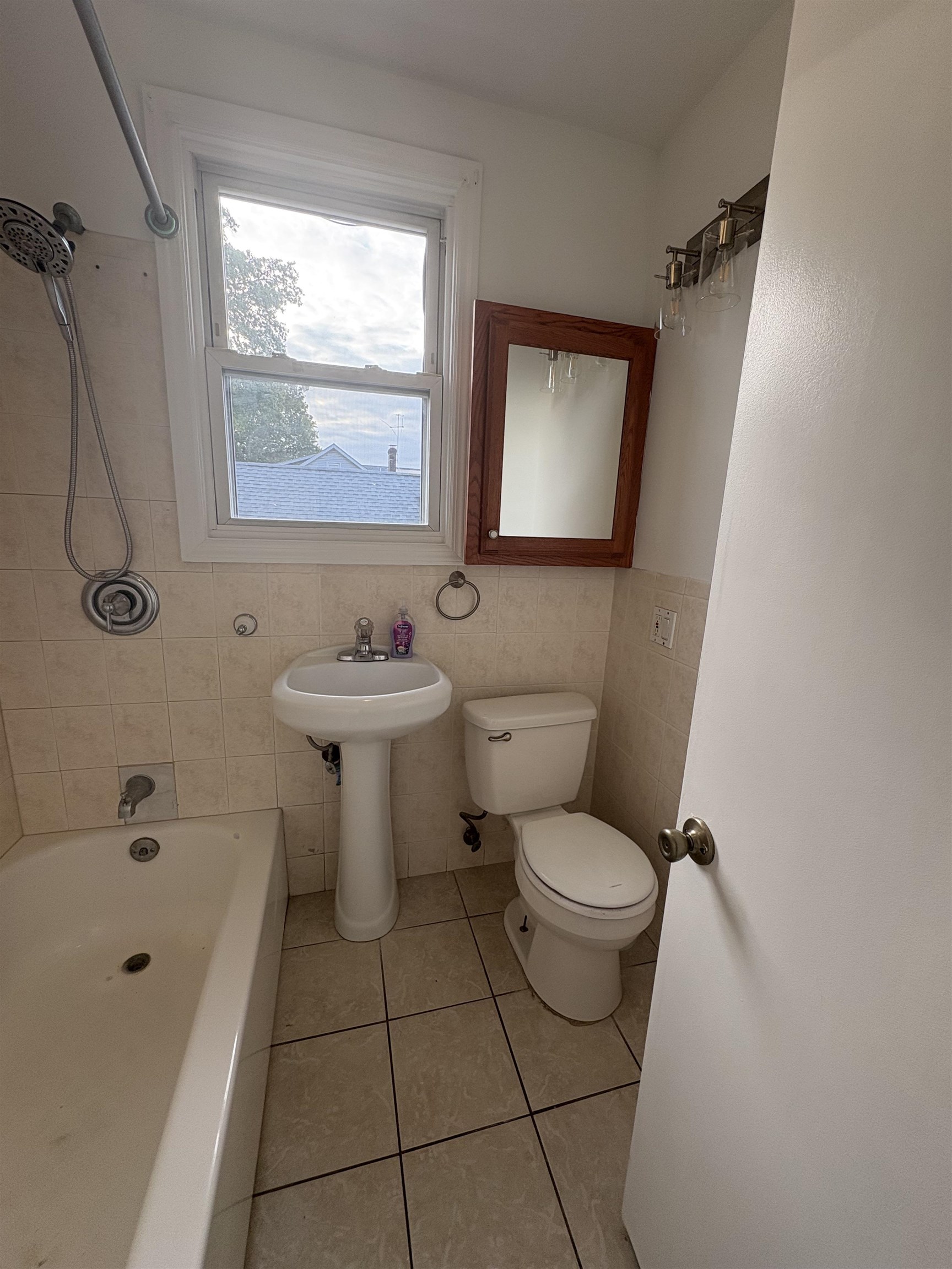 355 Princeton Avenue, Unit 2 Hillside, NJ 07205 - Photo 5 of 11 a bathroom with a toilet sink and mirror