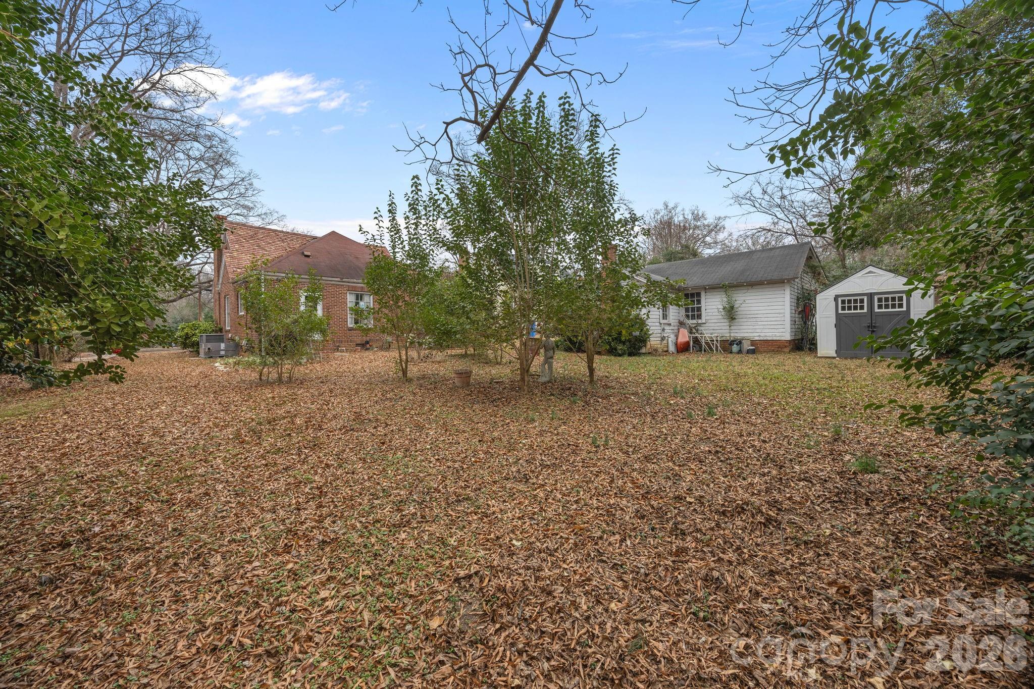 420 Spring Street Albemarle, NC 28001 - Photo 11 of 40 a view of backyard of house with outdoor seating and green space