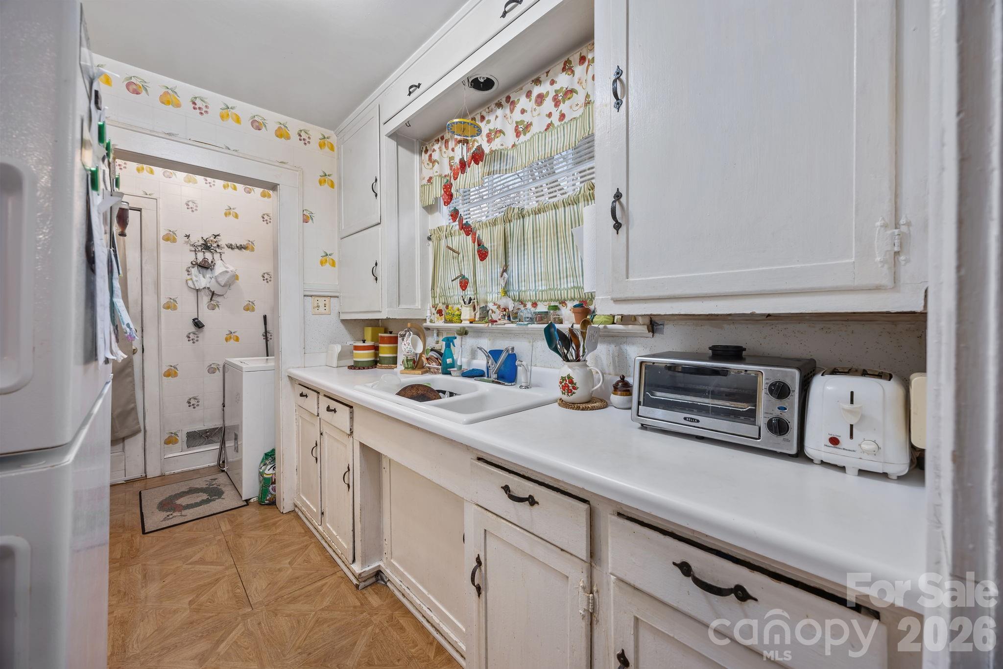 420 Spring Street Albemarle, NC 28001 - Photo 18 of 40 a kitchen with stainless steel appliances a sink and a refrigerator