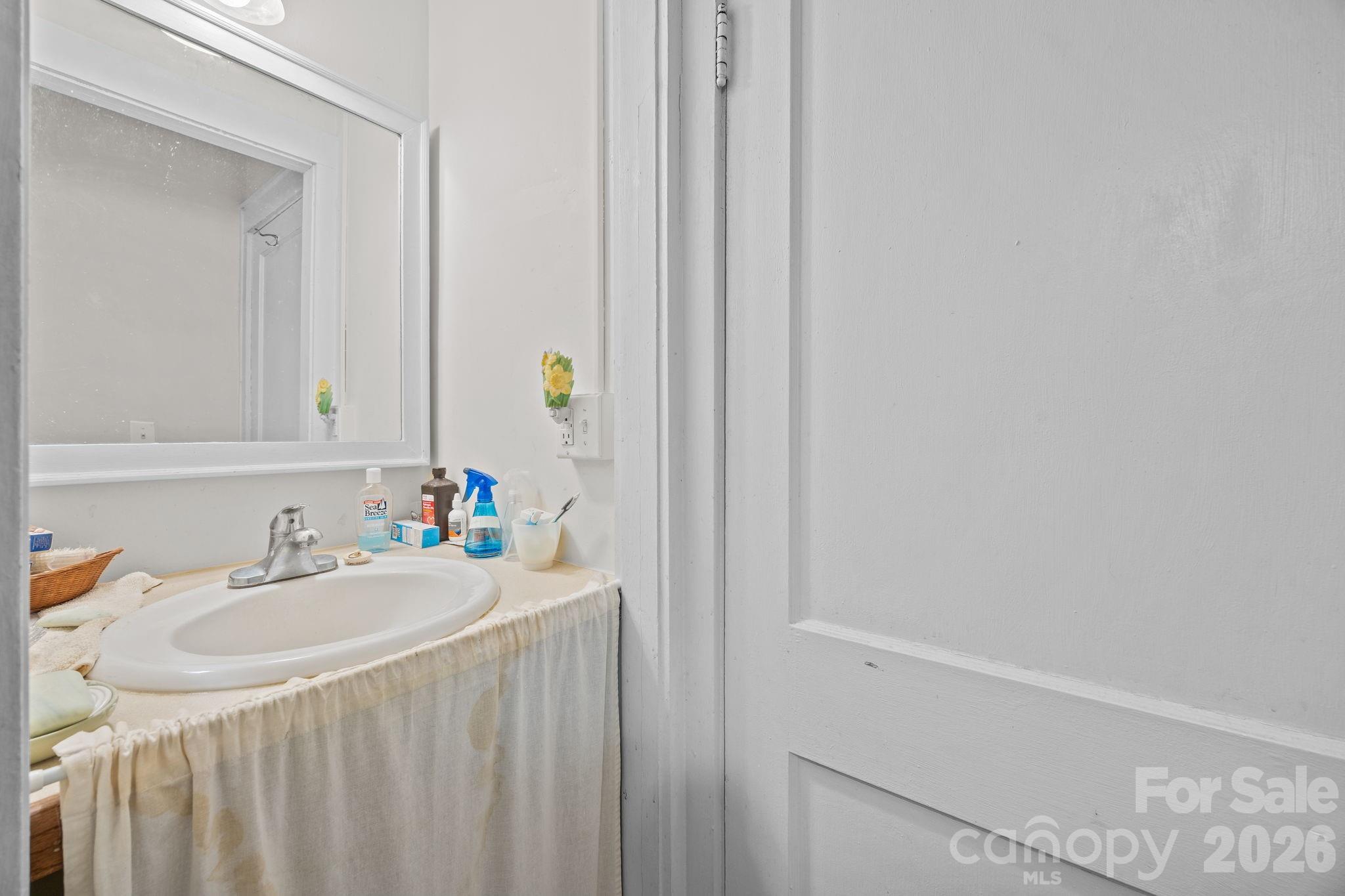 420 Spring Street Albemarle, NC 28001 - Photo 30 of 40 a bathroom with a sink and a mirror