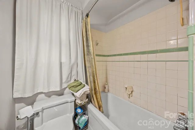 a room with furniture a rug toys and a window