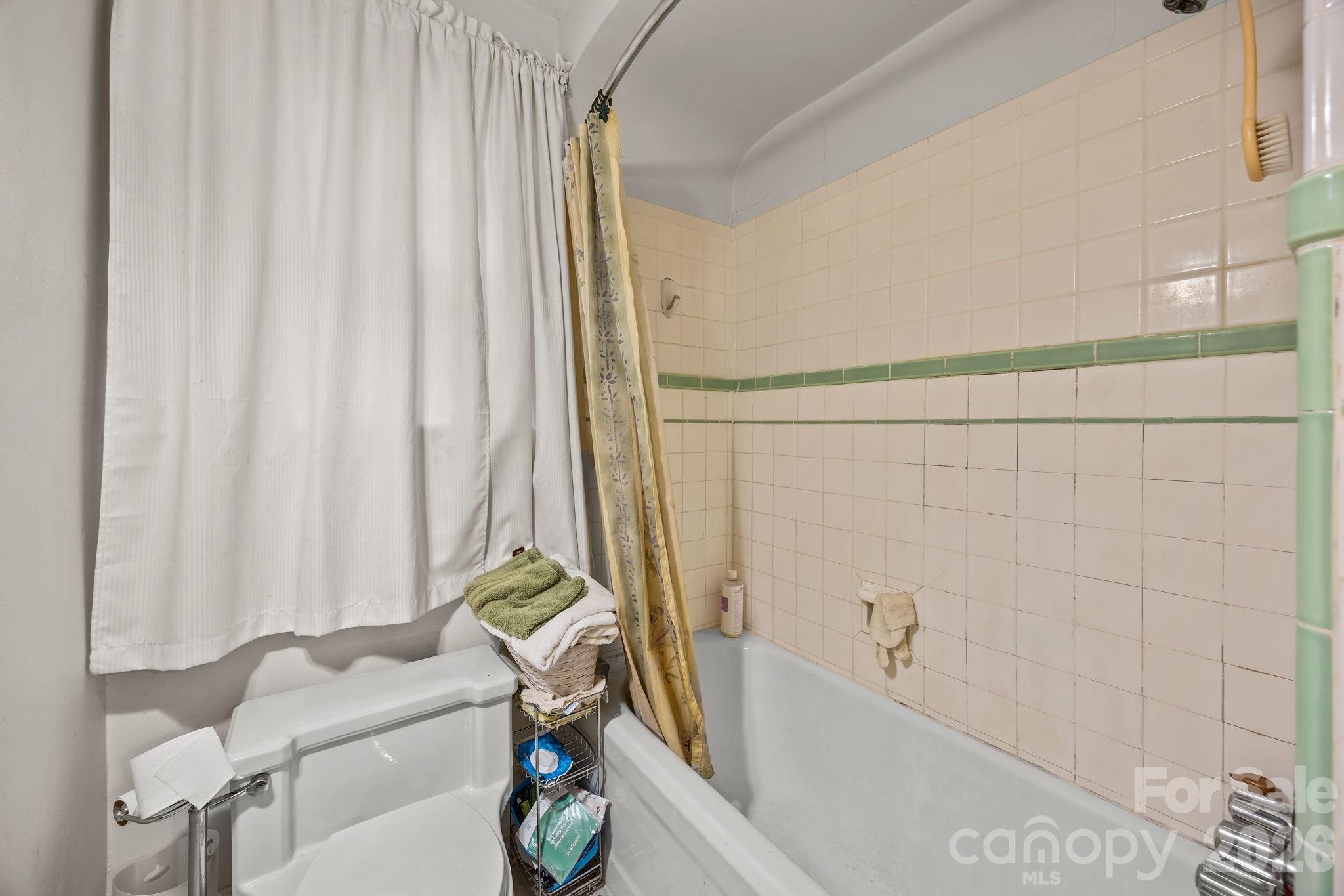 420 Spring Street Albemarle, NC 28001 - Photo 31 of 40 a bathroom with a bathtub and shower