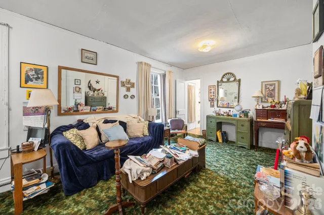 a bedroom with furniture and a flat screen tv
