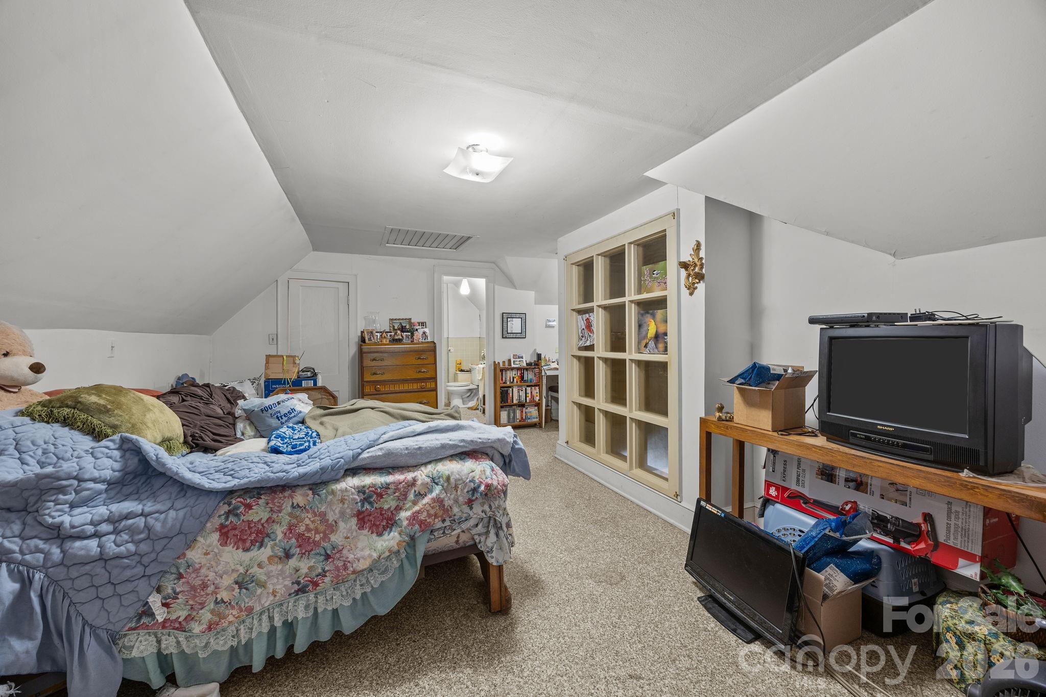 420 Spring Street Albemarle, NC 28001 - Photo 36 of 40 a bedroom with furniture and a flat screen tv