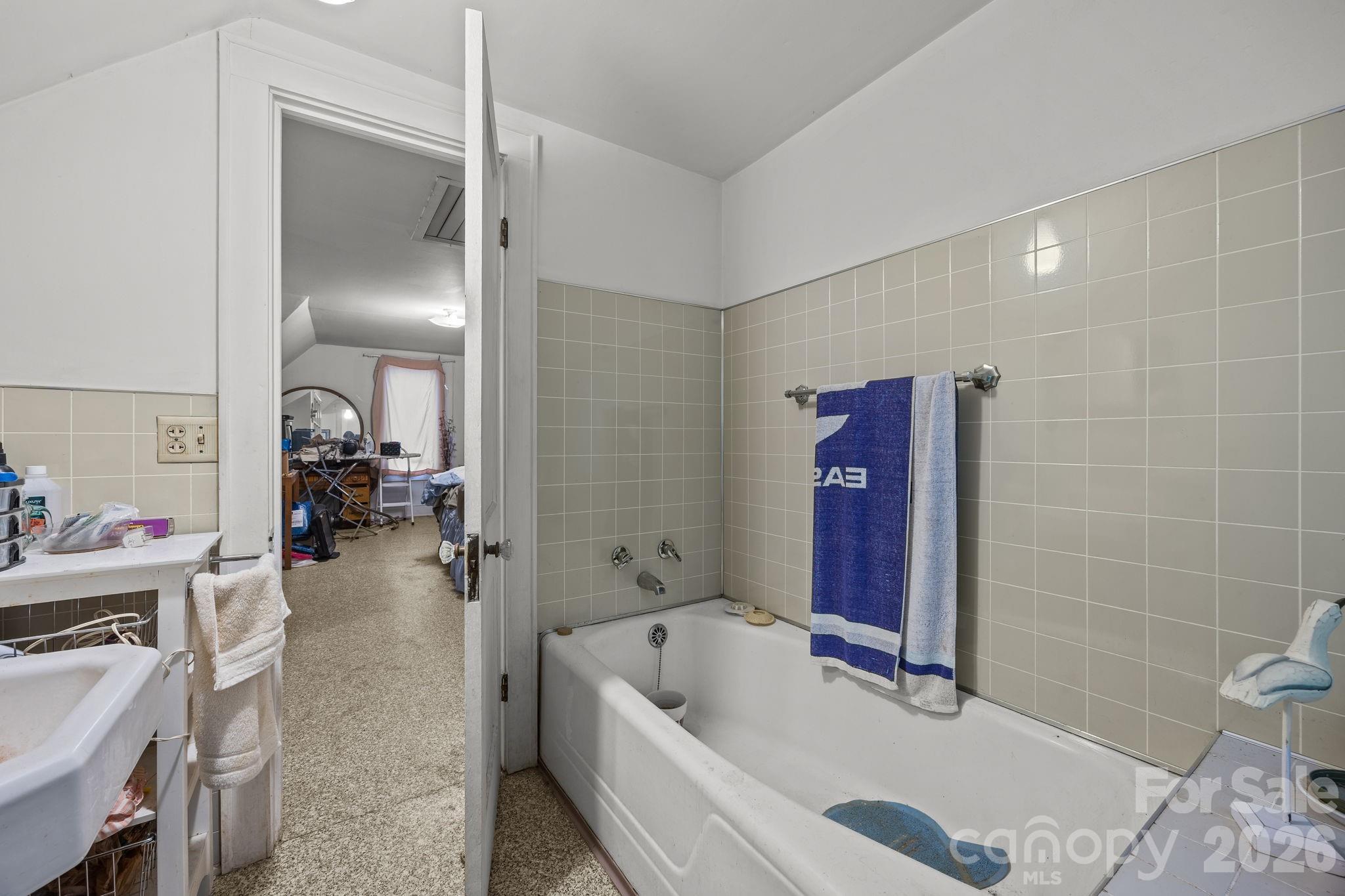 420 Spring Street Albemarle, NC 28001 - Photo 39 of 40 a bathroom with a tub a toilet and a shower