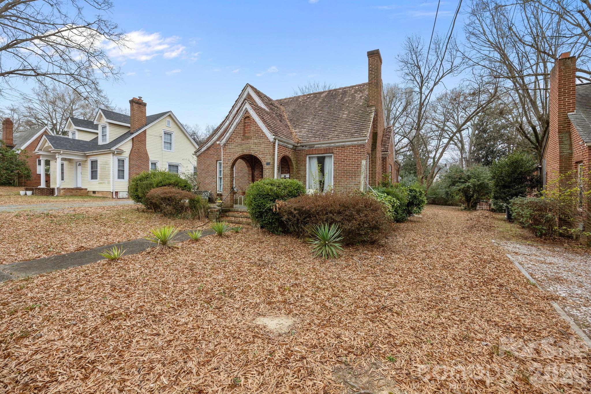 420 Spring Street Albemarle, NC 28001 - Photo 9 of 40 a front view of a house with a yard and garage