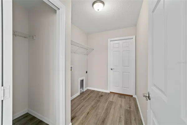 a view of a hallway with wooden floor