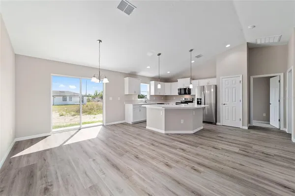 a view of kitchen and kitchen with wooden floor