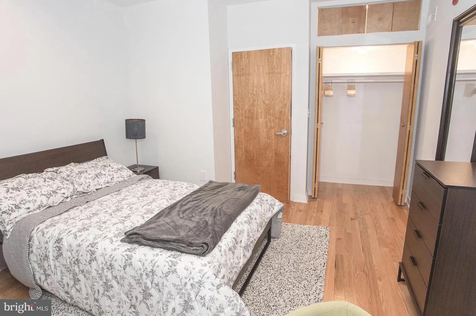 2016 Locust Street Philadelphia, PA 19103 - Photo 6 of 14 a bedroom with a bed and a mirror
