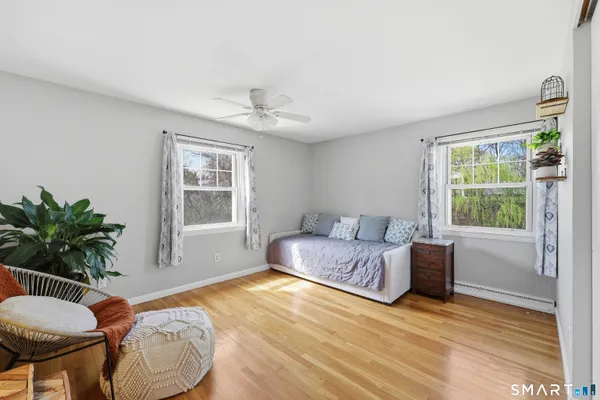 a spacious bedroom with a bed and a large window