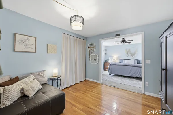 a bedroom with a bed and wooden floor
