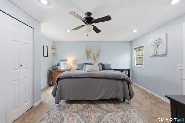 a bedroom with a bed and window
