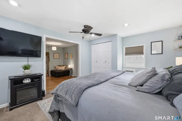 a bedroom with a bed and a flat screen tv