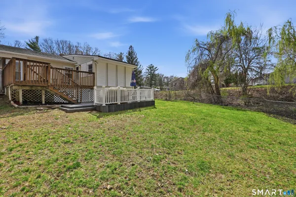 a view of a house with a yard and sitting area