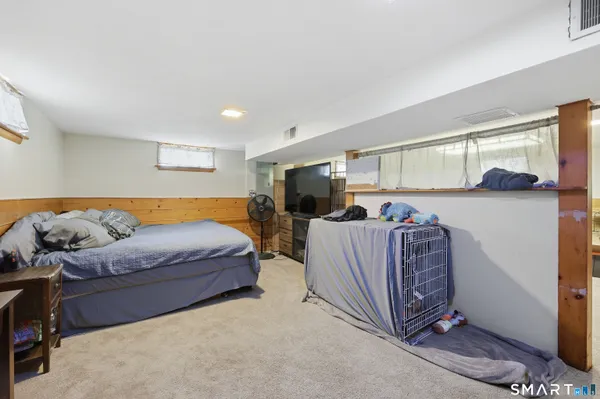 a living room with furniture a flat screen tv and a window