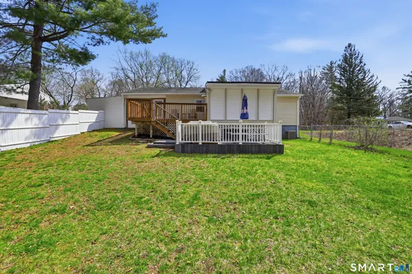 a view of a house with backyard and sitting area